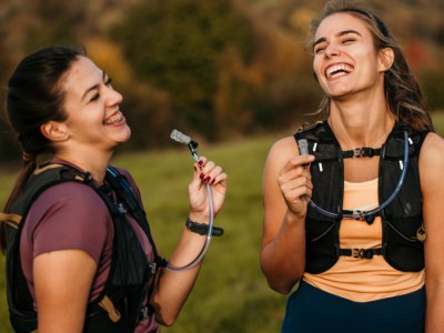 two women runners resting hydration packs
