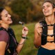 two women runners resting hydration packs