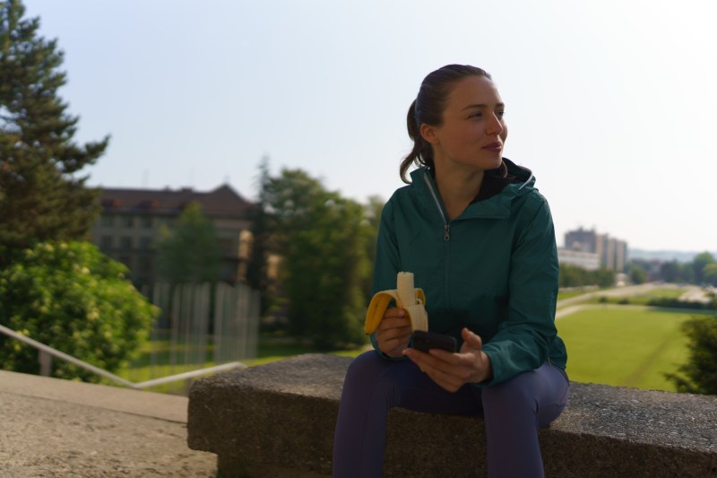 woman eating a banana after workout