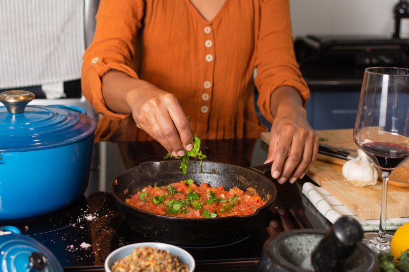woman cooking with herbs