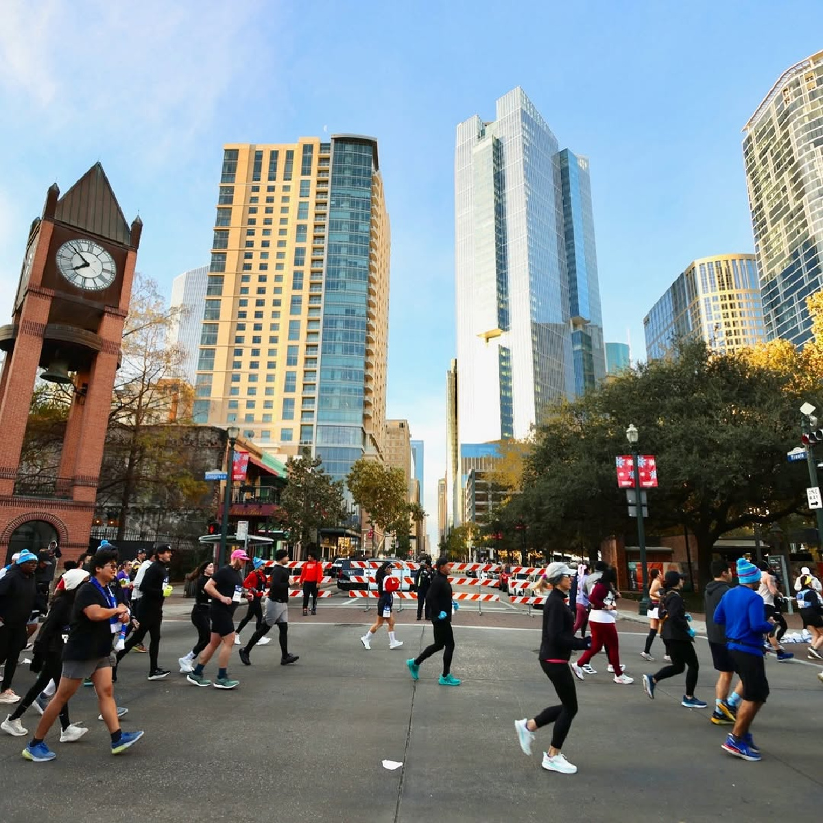 runners in front of houston skyline